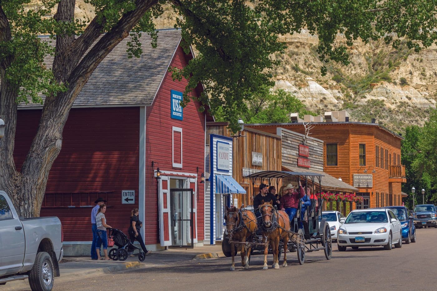 A horse and buggy carries people through downtown Medora, North Dakota