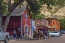 A horse and buggy carries people through downtown Medora, North Dakota
