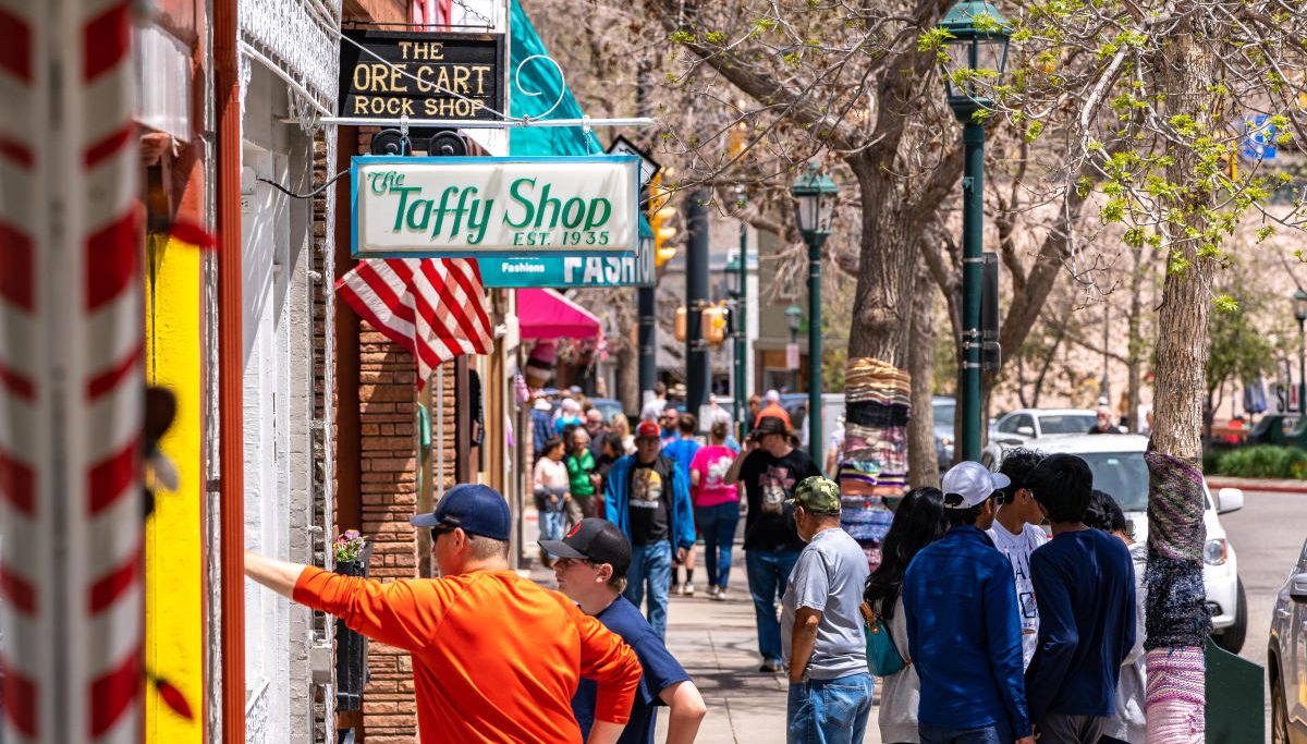 People walk and window shop at stores in downtown Estes Park, Colorado
